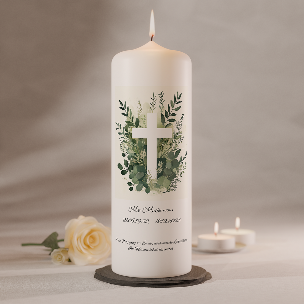 Personalisierbare Gedenkkerze mit Kreuzmotiv und Eukalyptuszweigen auf weißer Trauerkerze