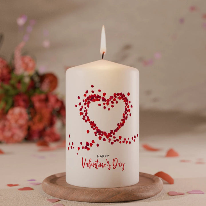 Weiße Valentinskerze mit rotem Herz aus Blütenblättern